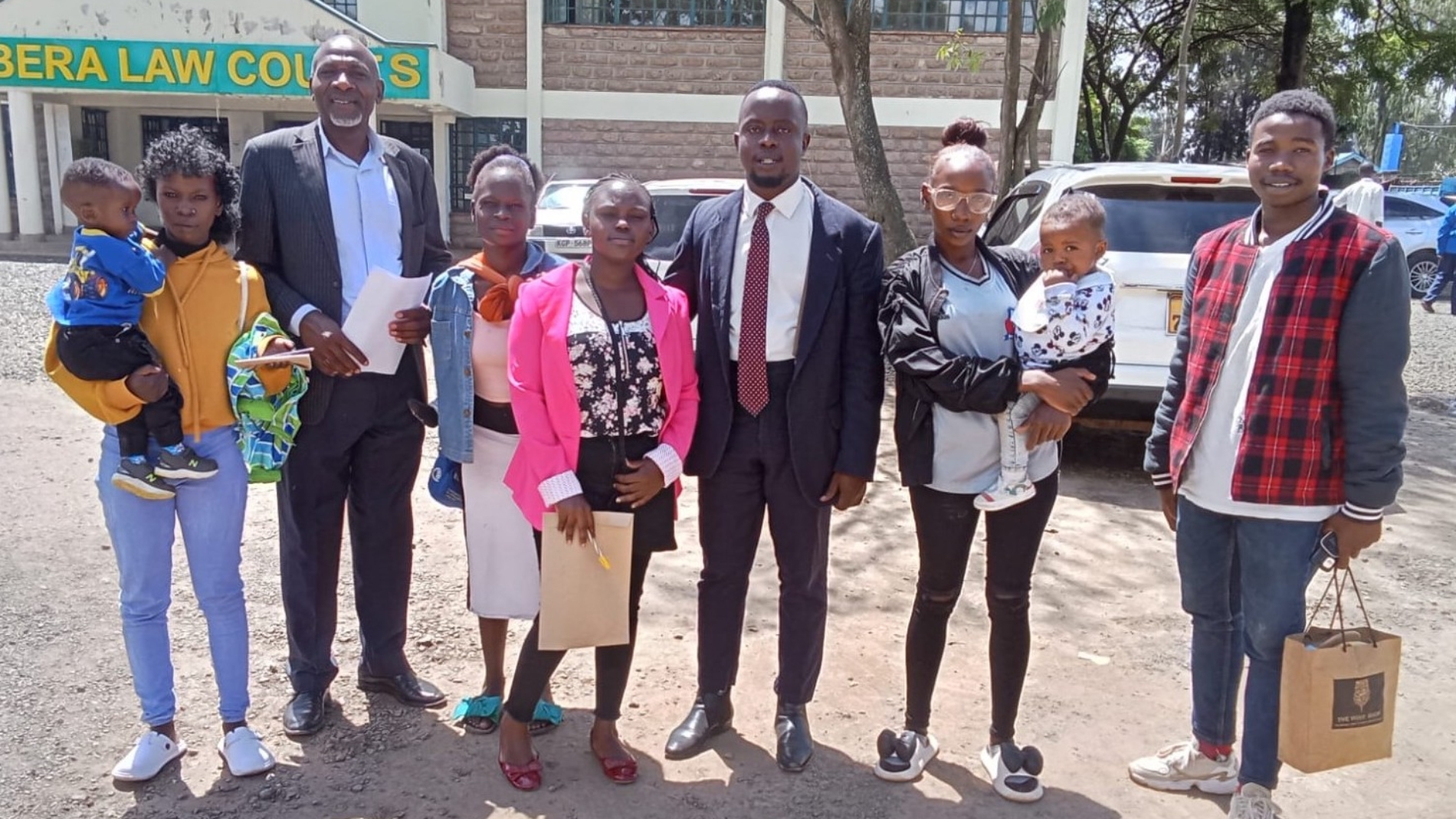 Valine, Advocate Owino, Anne, and the complainant’s family outside Kibra Law Court after the case withdrawal_